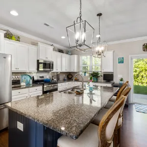 A bright, freshly cleaned kitchen with granite island